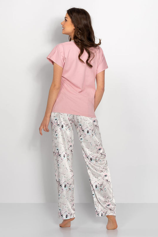 Female model shown from the back wearing a pastel pink short-sleeve cotton T-shirt with a straight cut and white floral print satin wide-leg trousers standing barefoot against a plain white background