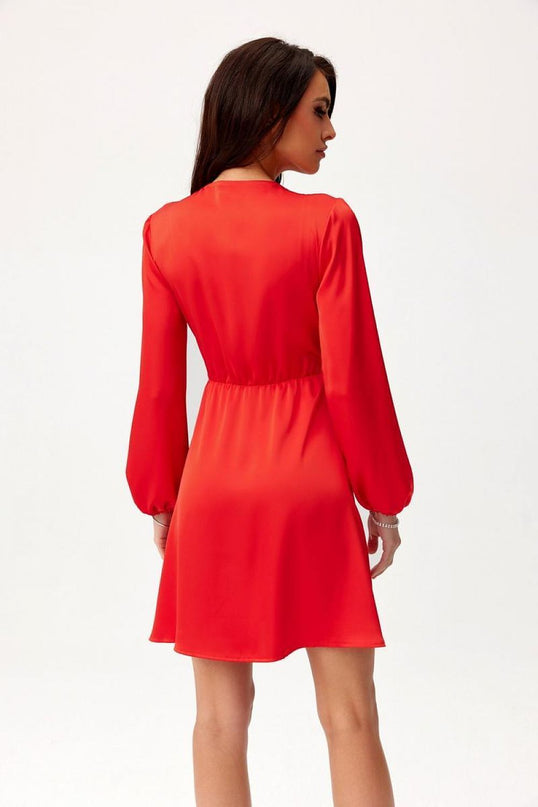Model wearing a red long-sleeve A-line mini dress in lightweight fabric posed from the back against a plain white background
