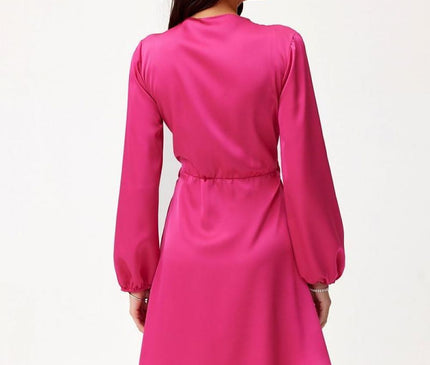 Female model stands with her back to the camera wearing a hot pink satin long-sleeve a-line mini dress with a cinched waist against a plain white background