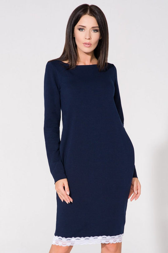 A female model stands facing forward wearing a navy blue stretch jersey long-sleeve bodycon midi dress with white lace trim at the hem against a plain white background