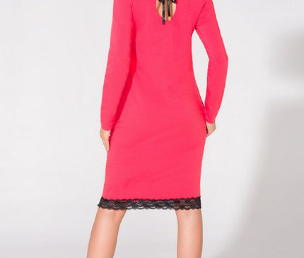 Model stands back to camera wearing a vibrant pink jersey long-sleeve midi dress with black lace hem and ribbon-tied keyhole back against a white studio background
