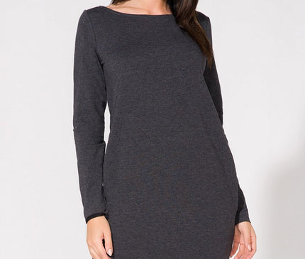 Female model in a charcoal grey knit long-sleeve straight-cut midi dress with lace trim at hem standing against a white studio background