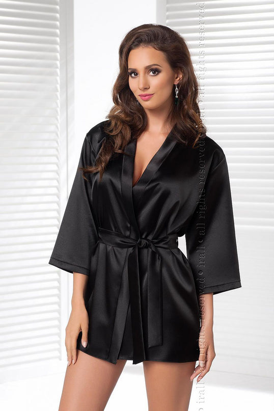 Model wearing a black satin short kimono-style robe stands facing camera with relaxed arms in front of white window blinds