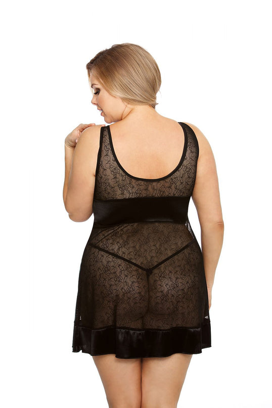 Plus-size model in a black lace and satin sleeveless babydoll dress with a scoop back and flared hem poses back to camera against a white background