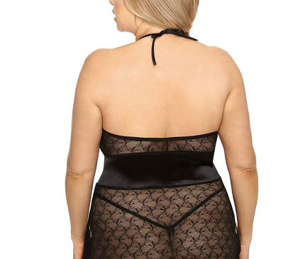 Curvy model seen from the back wearing a black lace halterneck babydoll slip with satin waistband against a white studio backdrop