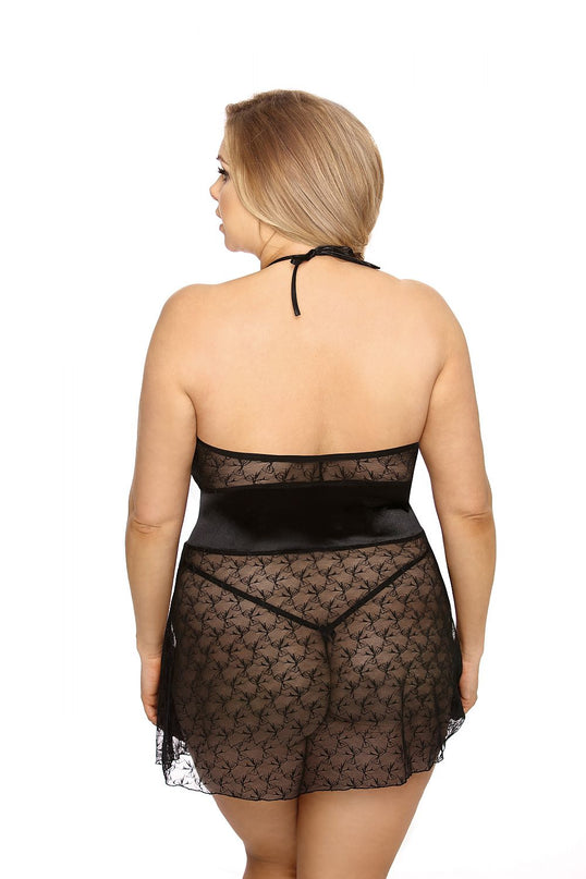 Curvy model seen from the back wearing a black lace halterneck babydoll slip with satin waistband against a white studio backdrop