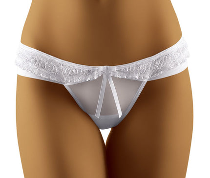 A model wearing a white sheer mesh and lace low-rise bikini-style thong standing against a plain white background