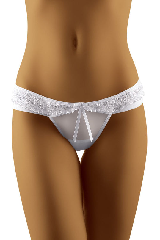 A model wearing a white sheer mesh and lace low-rise bikini-style thong standing against a plain white background
