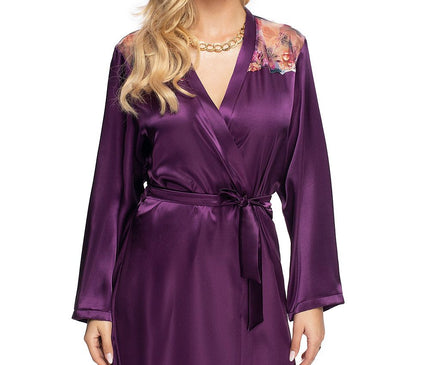 Female model stands against a white backdrop wearing a knee-length deep purple satin wrap robe with long sleeves a tie belt and floral mesh shoulder panels
