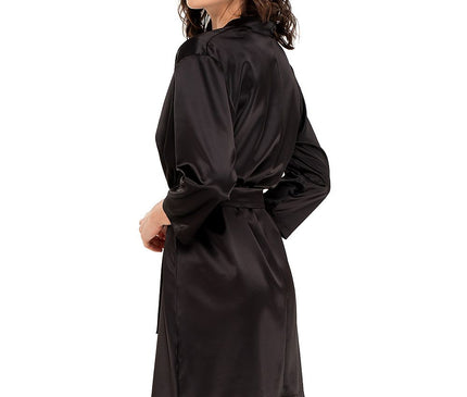 Female model in a black satin knee-length kimono-style robe with a waist belt standing in three-quarter pose against a white background