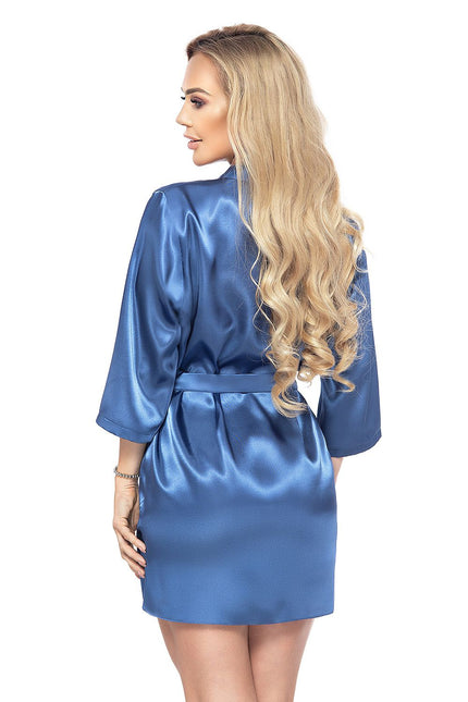Blonde model wearing a knee-length blue satin belted robe with three-quarter sleeves standing back to camera with head turned to the side against a white background