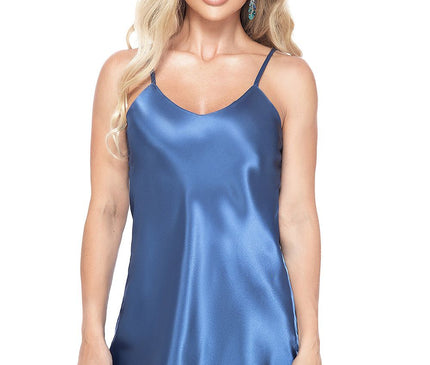 Female model in a standing pose wearing a short blue satin slip dress with thin straps against a white studio backdrop