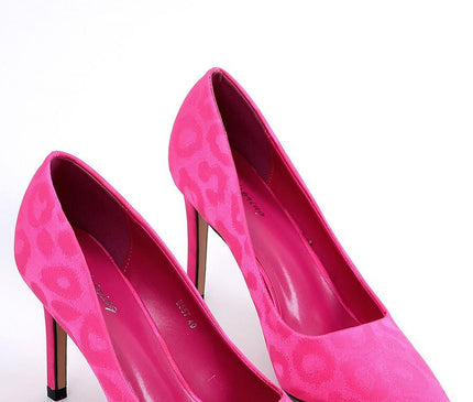 Pair of fuchsia pink suede court shoes with pointed toe and tonal leopard print posed side by side on a white background