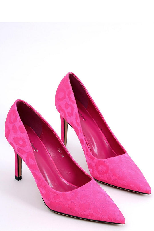 Pair of fuchsia pink suede court shoes with pointed toe and tonal leopard print posed side by side on a white background