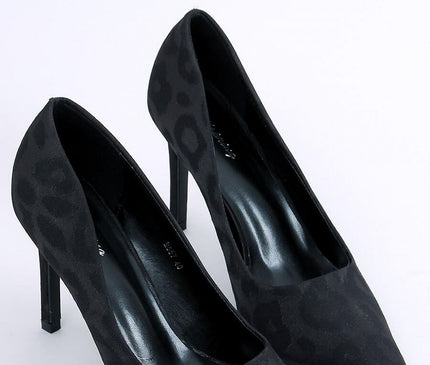 A pair of black suede pointed-toe stiletto pumps angled side by side on a white background
