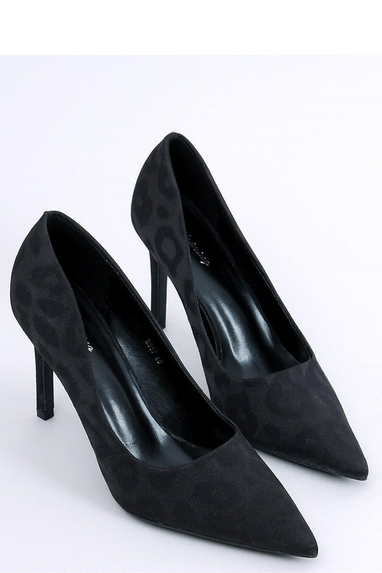 A pair of black suede pointed-toe stiletto pumps angled side by side on a white background