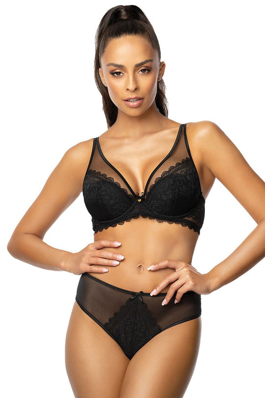 Female model wearing a black lace and mesh plunge bra with matching high-rise briefs stands front-facing with hands on hips against a plain white background
