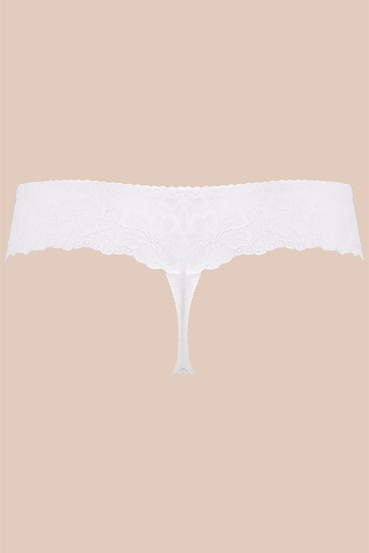 White lace thong with scalloped waistband and minimal cut shown in a flat lay against a plain beige background