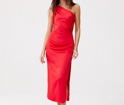 Female model standing against a plain white background in a red satin one-shoulder midi dress with a side slit posing with one foot forward