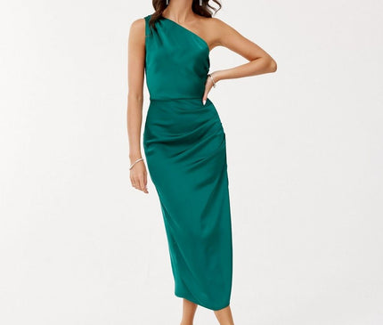 Female model in a slim-fit emerald green satin one-shoulder midi dress standing with one hand on her hip against a plain white background
