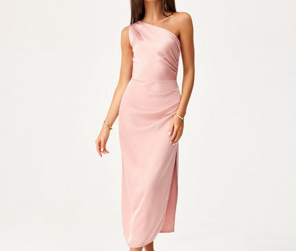 Model wearing a pale pink satin asymmetrical one-shoulder midi dress poses against a plain white background