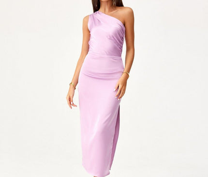 Female model wearing a lilac satin one shoulder bodycon midi dress stands with one foot forward and arms relaxed against a plain white backdrop