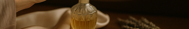 Person holding a perfume bottle with a blurred background and 'Satin London' branding.
