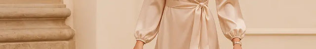 Woman in a beige satin dress walking in an elegant setting